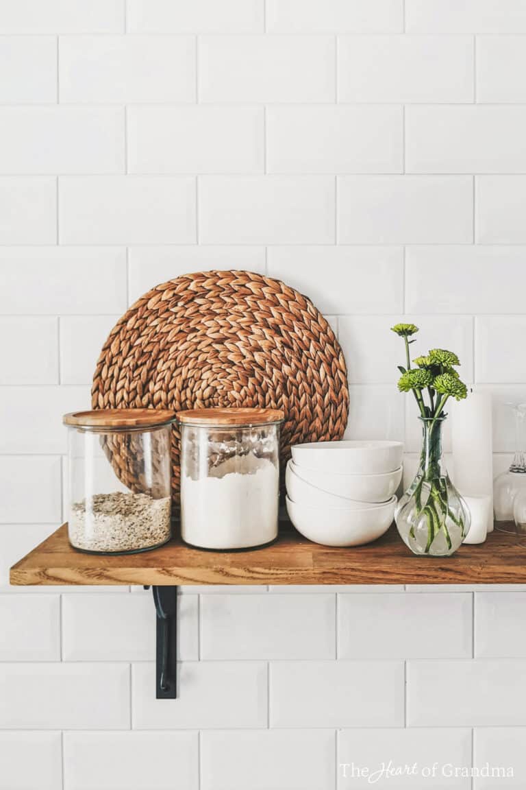Jars of ingredients sitting on an open wooden shelf.