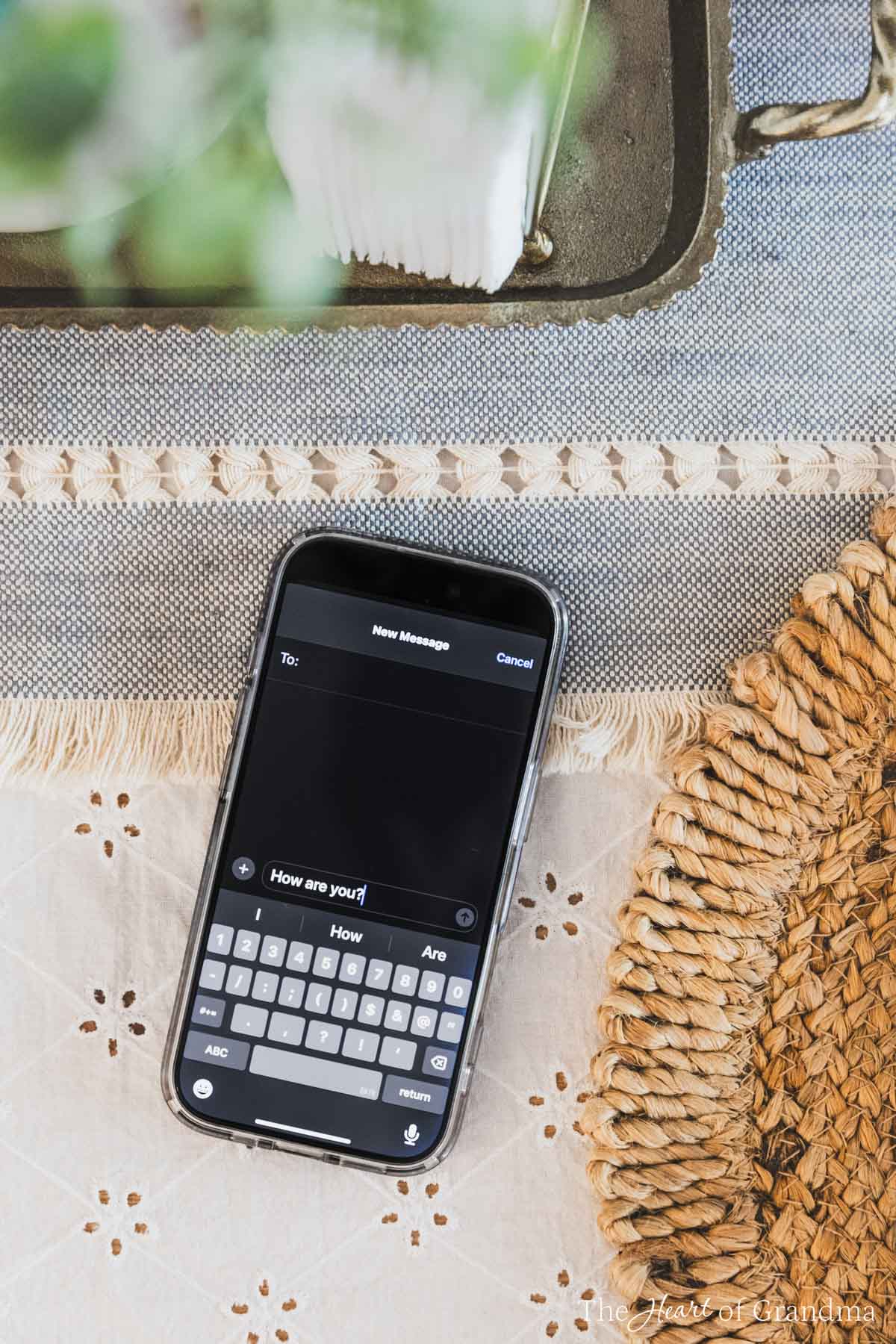 An iPone on a kitchen table open to the text messages.