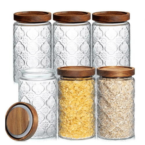 Fancy glass canister set with wooden lids.