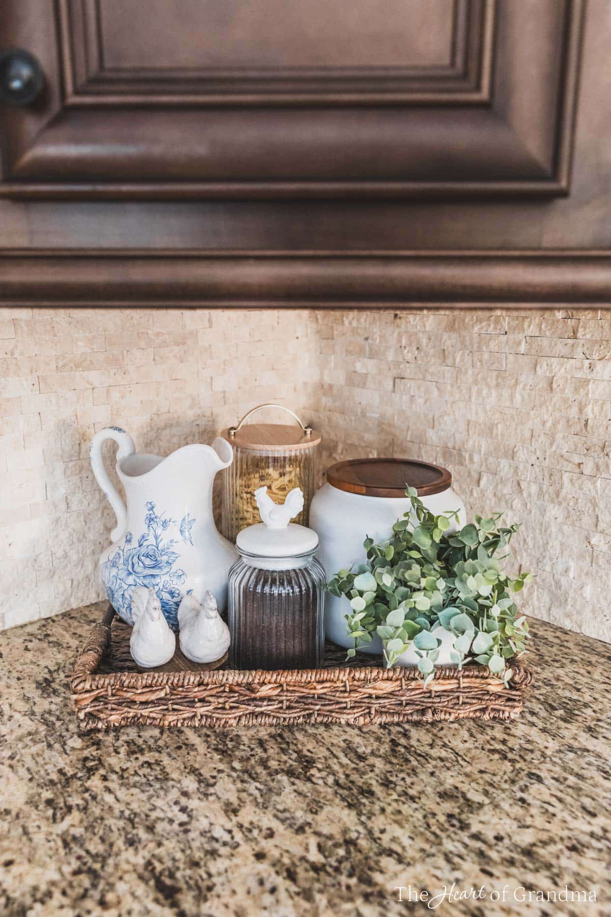 A tray filled with farmhouse decor, a pitcher, salt and pepper shakers, and a jar of coffee.