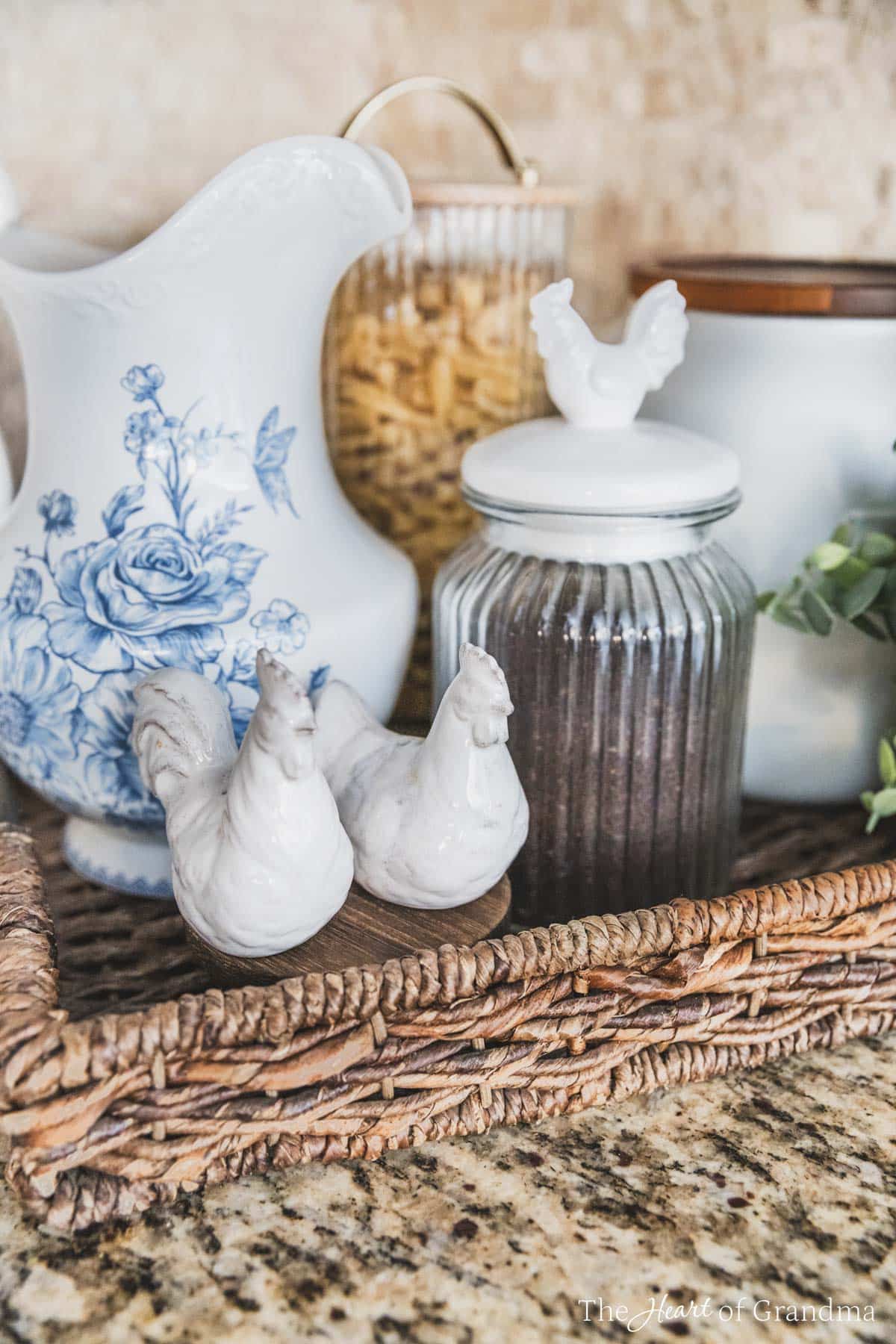 A tray filled with farmhouse decor, a pitcher, salt and pepper shakers, and a jar of coffee.
