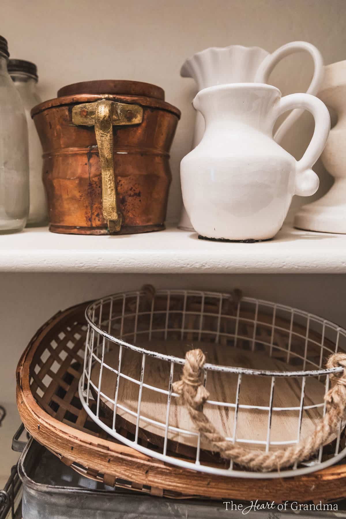 Home decor items in a decor closed organized by like items.
