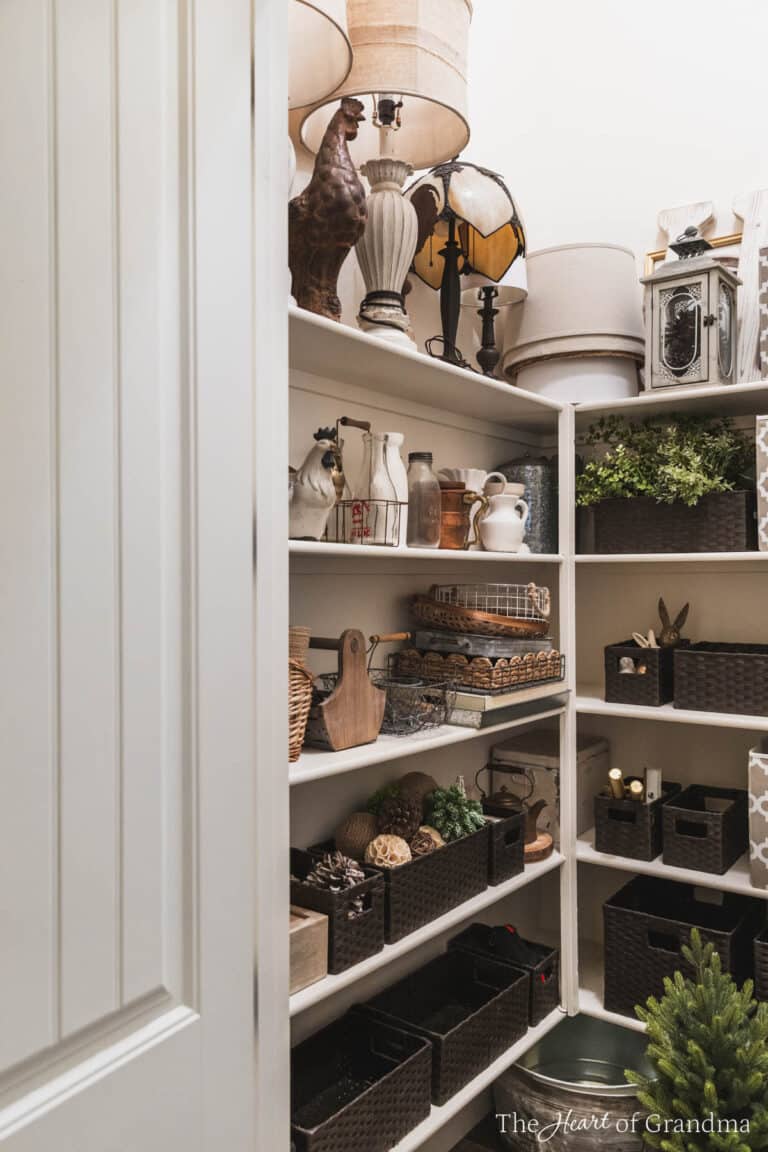A closet filled with home decor items in dark brown baskets.